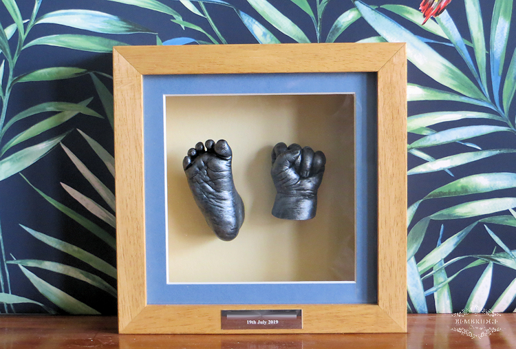 silver baby casts in solid wood frame with blue mount